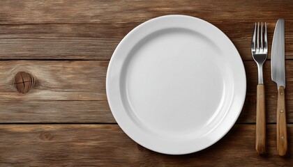 Top View Of An Empty White Plate With Cutlery On A Wooden Surface. Ample Copy Space Available In The Image.