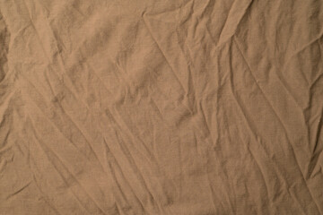 Close-up of light brown fold plain fabric.Light brown fold plain fabric texture and background.