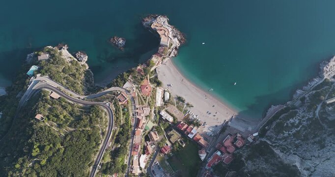 Aerial view of the beach at Erchie, where turquoise waters meet the sandy shore, embraced by rugged cliffs and vibrant greenery, Erchie, Amalfi Coast, Italy.
