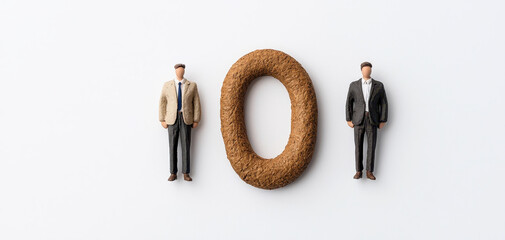 Minimal composition featuring wooden number zero between two business figures on a white background. Suitable for finance, balance, comparison, equality, accounting, and business concepts.