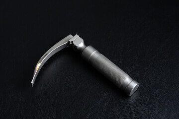 Laryngoscope on a dark background. Horizontal shot.