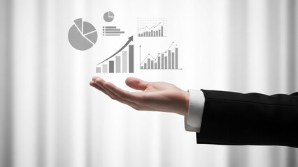 A hand holding various business graphs and charts on a blurred background