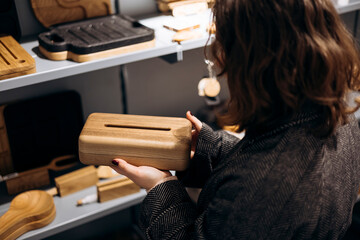 Handmade wooden napkin dispenser in store with natural aesthetic.