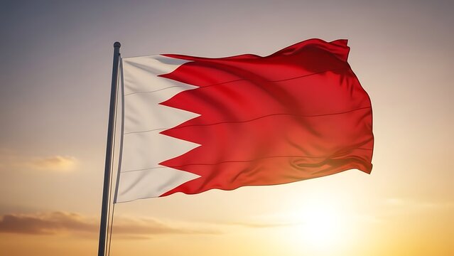 The national flag of bahrain waving against a golden sky at sunset