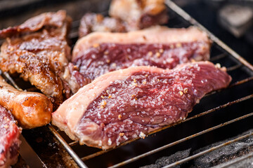 Raw Picanha Steaks with Rock Salt on a Barbecue Grill
