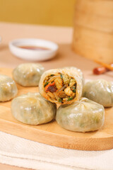 Steamed Asian Dumplings with Vegetable Filling on Wooden Board