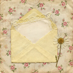 A vintage composition with an open envelope, blank note, and a dried daisy on a shabby chic floral background. Romantic and nostalgic mood.