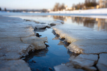 Obraz premium A captivating image showcasing the beauty of spring thaw, with water emerging from icy crevices, symbolizing renewal and the transition of seasons.