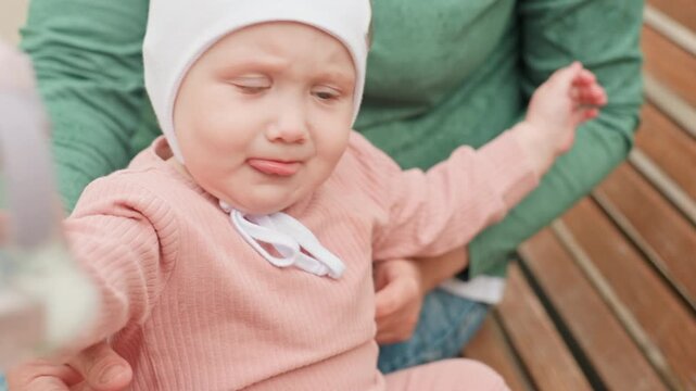 Child Reaches Toy, Young Child Extends Hand Toward Plaything Nearby, Infant Attempts To Grasp Toy With Help From Guardian, Young Child Reaches Out With Excitement For Toy While Supported By Parent