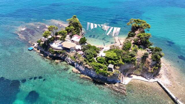 Aerial drone cinematic video of scenic small islet and sandy beach of Cameo in bay of Laganas, Zakinthos island, Ionian, Greece