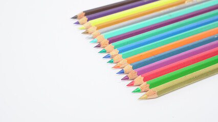 Obraz premium A collection of colorful drawing pencils on a clean white surface for art and education.