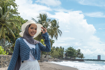A young woman enjoys a holiday on a beautiful beach in Anyer, Indonesia.