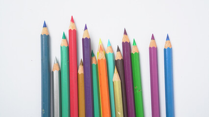 A collection of colorful drawing pencils on a clean white surface for art and education.