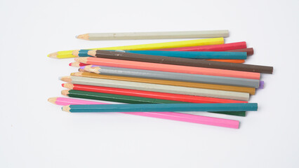 Fototapeta premium A collection of colorful drawing pencils on a clean white surface for art and education.