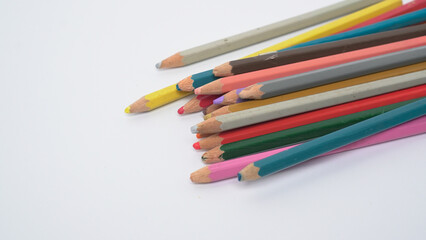 Fototapeta premium Close up of various colored pencils lying on a white background