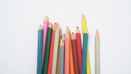 Fototapeta premium A collection of colorful drawing pencils on a clean white surface for art and education.