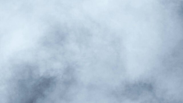 Abstract white smoke in slow motion. Smoke, Cloud of cold fog in light spot background. Light, white, fog, cloud, black background, 4k, ice smoke cloud. Floating fog.	