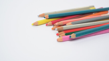 Fototapeta premium A collection of colorful drawing pencils on a clean white surface for art and education.