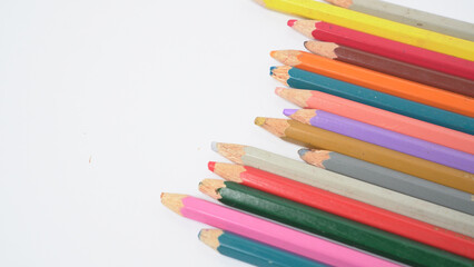 Fototapeta premium A collection of colorful drawing pencils on a clean white surface for art and education.