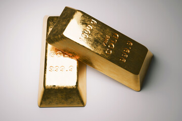 Two brilliant, heavy gold ingots marked 1000g and 999.9 fine gold, symbolizing ultimate wealth, luxury investment, and financial security against a soft-focus background