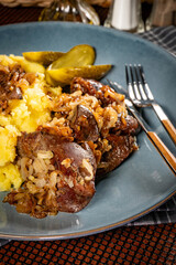 Turkey liver with mashed potato and pickled cucumber.