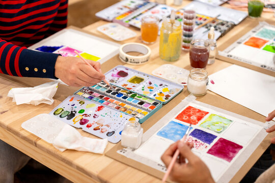 People learning watercolor painting during art workshop creating artwork