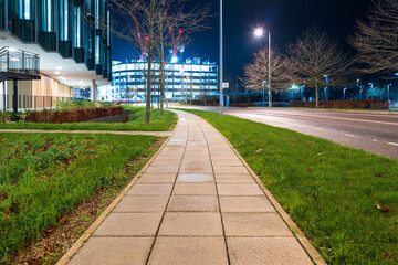 Shallow focus of a pedestrian footpath seen adjacent to a famous biotech and drug company. Located of the Cambridge Biotech Campus in the UK, seen at dusk.
