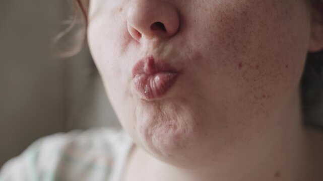 Overweight caucasian woman mouth biting and chewing pancake closeup. Act of chewing food is depicted with open mouth and pleasure.