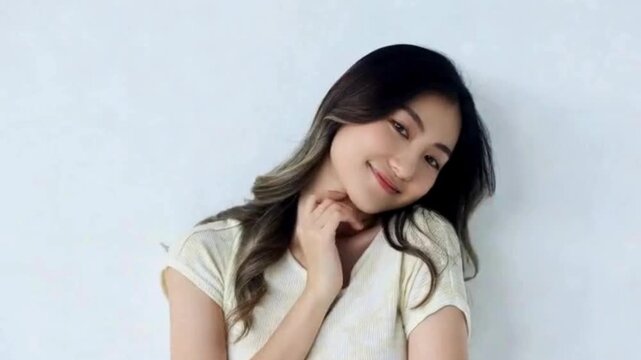 A captivating portrait of a woman radiating natural beauty and effortless grace, her smile and the way she gazes directly at the camera create an intimate and engaging experience.