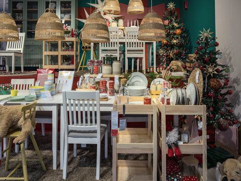 IKEA festive showroom dining setup with tableware, and decorated Christmas trees.