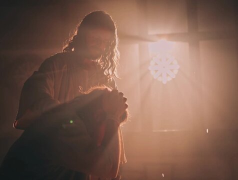 Jesus gives communion to a parishioner
