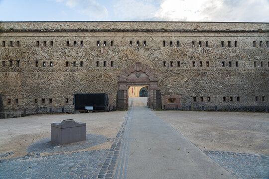 View of the fortress walls with multiple windows and an arched entrance, standing majestically against the sky, Ehrenbreitstein Fortress, Koblenz, Germany.