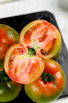 Fresh Ripe Tomatoes Cut in Half Showing Red Flesh and Seeds - Authentic Garden Vegetables