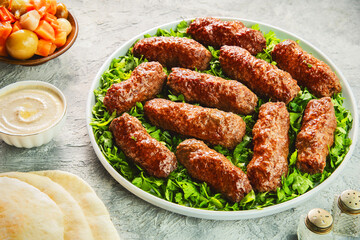 Arabic Cuisine; Grilled Kofta Kebab is one of the most popular dishes in Egypt and entire Mediterranean region. Served on bed of fresh parsley with pita bread, tahini sauce and pickles.