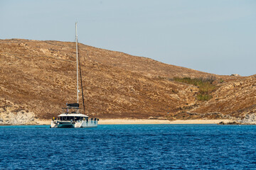 Sailboat anchored near Delos island sandy beach Greece © Juan