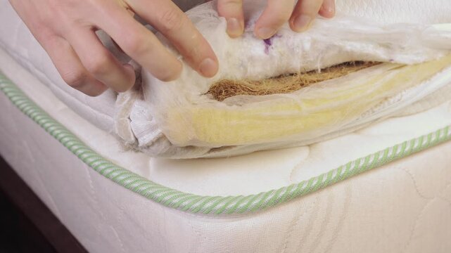 Man chek internal filling of the mattress with wood shavings.