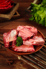 Premium Raw Beef Steaks on Wooden Board with Fresh Herbs