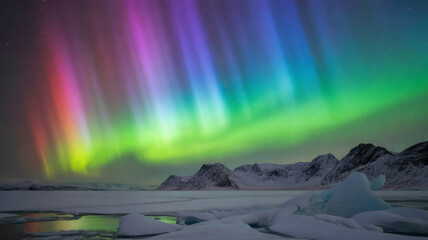 Colorful aurora borealis over a snowy landscape with icebergs and mountains under starry sky