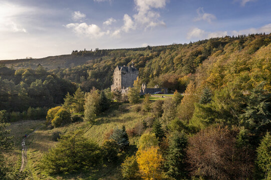 Aerial view of the imposing Neidpath Castle, standing sentinel amidst the vibrant tapestry of autumn foliage, a medieval stronghold in the Scottish Borders., Peebles, Scotland, United Kingdom.