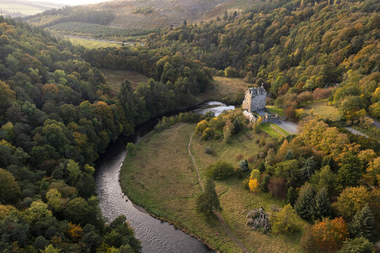 Aerial view of Neidpath Castle amidst autumn's vibrant tapestry, where the River Tweed meanders through the valley's heart, Peebles, Scotland, United Kingdom.