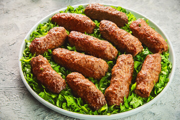 Arabic Cuisine; Grilled Kofta Kebab is one of the most popular dishes in Egypt and entire Mediterranean region. Served on bed of fresh parsley .