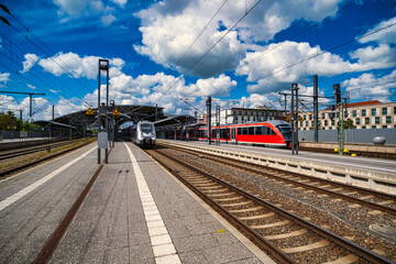 Fototapeta premium Contemporary train scene, fastmoving metropolitan train arriving amidst busy travelers and signals