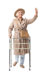 Senior woman in trench coat with walker waving hand on white background