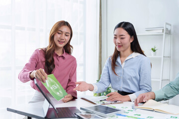 Businesswomen meeting about ESG strategy, green energy, and corporate sustainability at an office table with solar panel