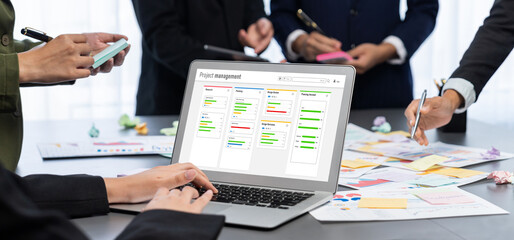 Analyst team use sticky note for creative and analytic brainstorm for business idea with BI data dashboard on laptop screen. Analysis financial data visualization tech for marketing strategy. Prodigy