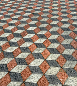 View of a mesmerizing geometric dance of red, black, and gray blocks creates a captivating 3D illusion underfoot, Kuala Lumpur, Federal Territory of Kuala Lumpur, Malaysia.