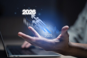 A person holds a Business growth forecast with futuristic data analytics for 2025 to 2026 showing hand typing on laptop, upward arrow trend, financial planning and strategic investment.