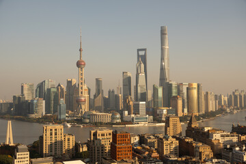 View of towering skyscrapers piercing the skyline, a symphony of glass and steel reflecting the golden light of dawn, Shanghai, Shanghai, China.
