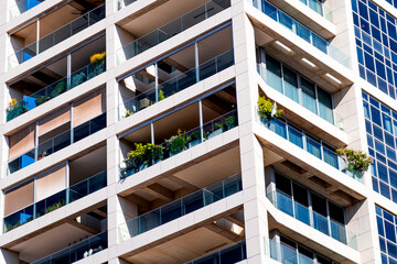 Fototapeta premium Facade of modern residential building with balconies against, Tel Aviv, Israel. Futuristic architecture in a developing Middle Eastern city.