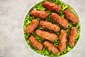 Arabic Cuisine; Grilled Kofta Kebab is one of the most popular dishes in Egypt and entire Mediterranean region. Served on bed of fresh parsley .Top view with copy space.
